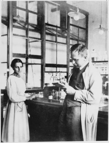 Lise Meitner and Otto Hahn in the laboratory at the Kaiser Wilhelm Institute for Chemistry, 1913. Source: Wikimedia Commons