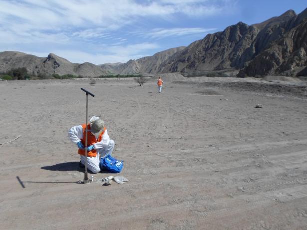 Lab personnel taking baseline soils samples near a mining waste depository in northern Chile