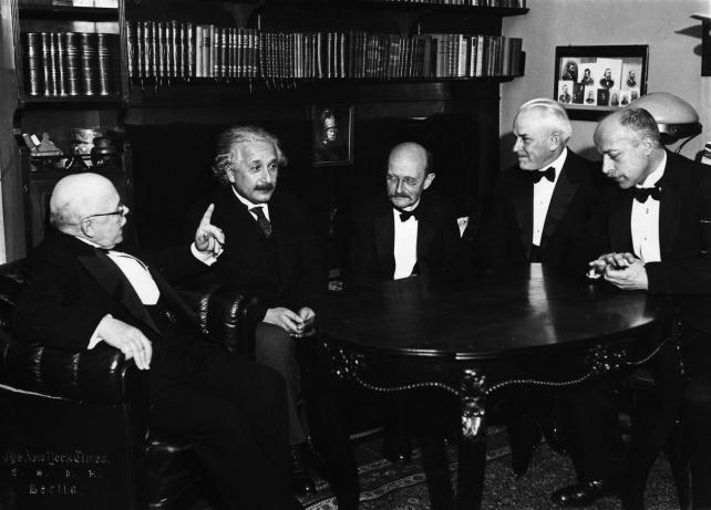 Photograpy showing Walther Nernst, Albert Einstein, Max Planck, Robert Milikan, and Max von Laue debating