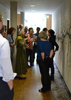 Rohini Devasher with Lorraine Daston and members of Department II (Ideals and Practices of Rationality) in front of the mural Parts Unknown.