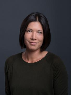profile picture of Alexandra Hui (dark green shirt, half-lenght dark hair), dark grey background