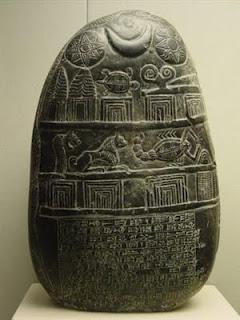 photo of a black stone with astrological engravings
