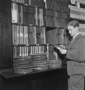 Sound archives. An unknown man handles tapes in tape library.