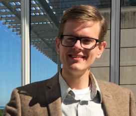 profile picture of Joseph Clarke posing in front of a modern building