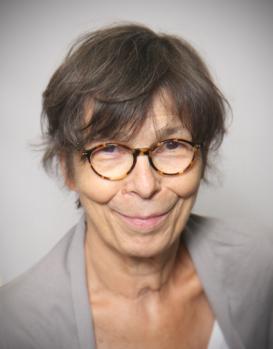 profile picture of Marie-Madeleine Mervant-Roux (glasses, short hair, grey shirt), grey background
