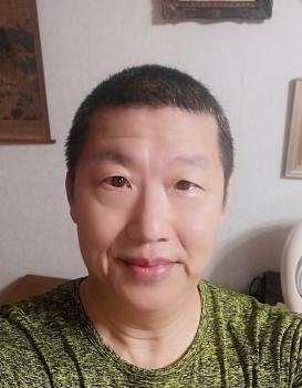 Ping-tzu Chu wearing a green shirt, facing directly in the camera
