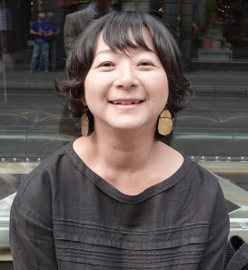Ayako Sakurai sitting and smiling into the camera