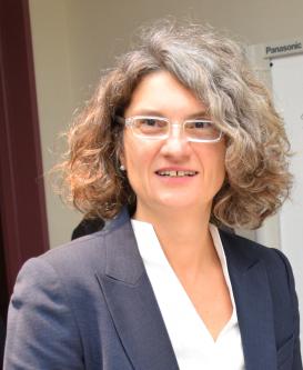 Maria Rentetzi wearing a grey blazer and glasses 
