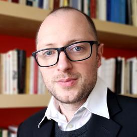 Daniel Morgan in front of a bookshelf