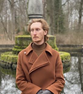 Gavin Steingo in a park in front of a statue