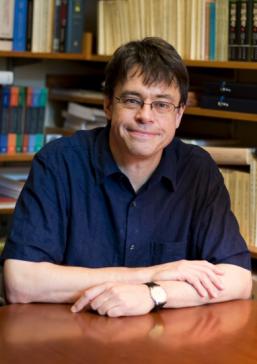 Michael Puett sitting in front of a book shelf