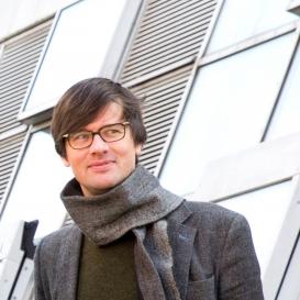 Robert Meunier in front of a glass façade