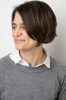 headshot of Janina Wellmann wearing a grey sweater