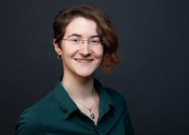 profile picture of Agnes Bauer wearing a green shirt in front of a dark background