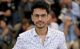 Headshot of Shaunak Sen in front of a blurry background