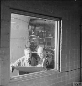 A shop superintendent instructing a worker, probably at Spring Quarry, Wiltshire, England, 1942