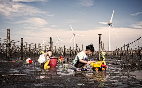 Children playing in a dried up seabed