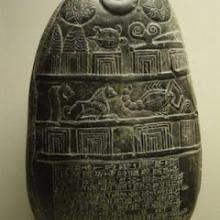 photo of a black stone with astrological engravings