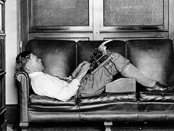 The sportsman and sports journalist Lauri "Tahko" Pihkala is writing on a typewriter in 1932. The typewriter is attached to the thighs with Knefix pliers, developed by Pihkala, so that the writer can write in any position needed.