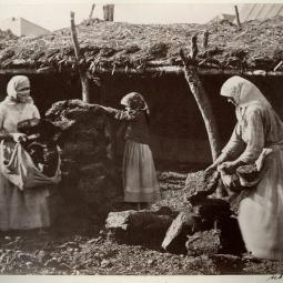 A photograph showing Cossack women carrying manure bricks (kiziak), dried and pressed, to the barn, from the grassroot visual ethnography of Southern Cossacks settlements by Ivan Boldyrev (b.1850-after 1917).  Source: Boldyrev I. V. Vidy i tipy 2-go Donskogo okruga stanitz Tsymlianskoj, Kumshatskoj i Esaulovskoj. S.l.; 1876. National Library of Russia, digital archive, open access