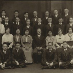 Portrait of Paul Monroe sitting surrounded by his students at Teachers College