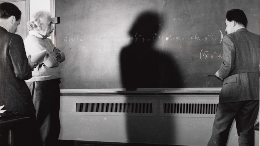 Albert Einstein at Princeton, standing in front of a blackboard