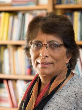Meera Nanda in front of a book shelf